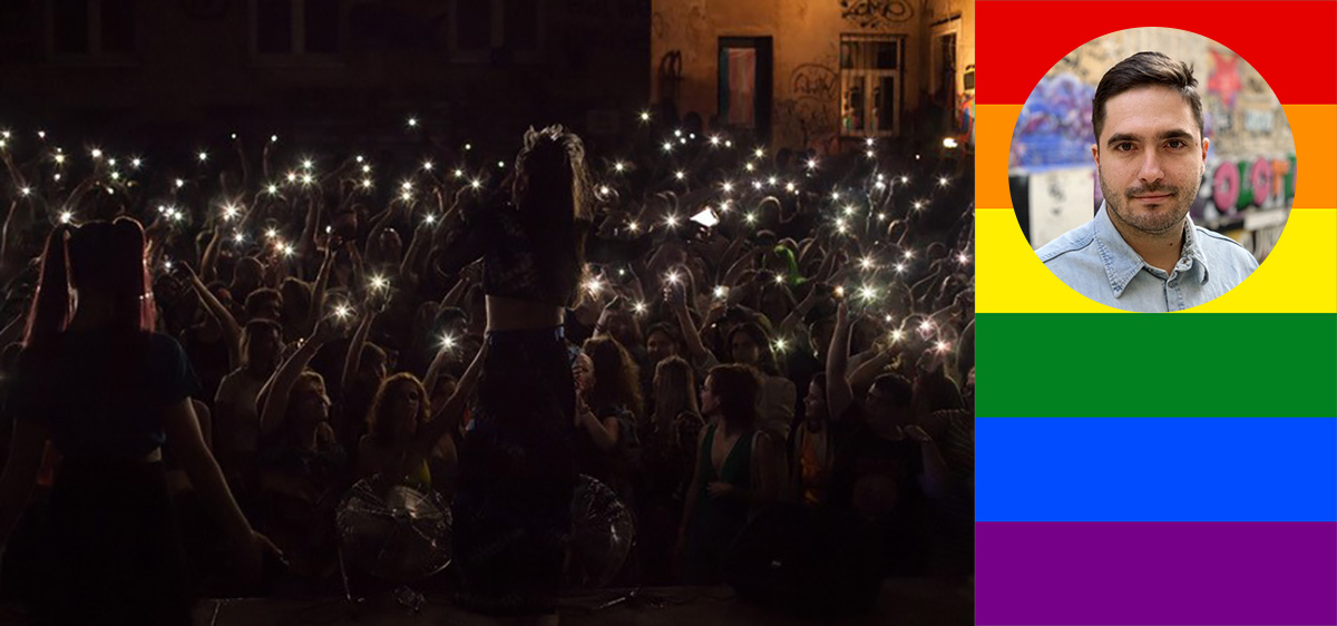 I crowd gathering in the dark with candled lights, on the left a portrait photo of a man with rainbow colours in the background.